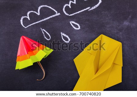 Origami yellow red blue cartoon protection umbrella on a white background