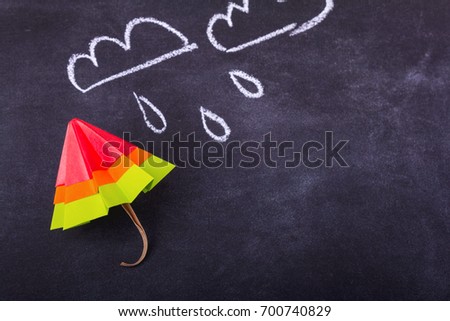 Origami yellow red blue cartoon protection umbrella on a white background