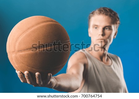 close-up shot of handsome man with basketball ball