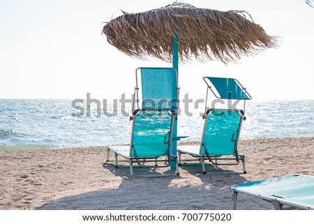 Picture of blue sunbeds and umbrella on the Black Sea beach in Vama Veche, Romania