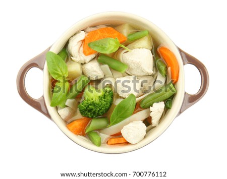 Tureen with delicious turkey soup on white background