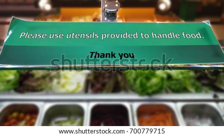 Sign at a Salad Bar Requesting Customers to Use Utensils