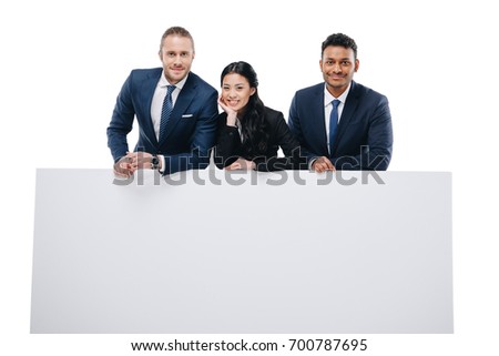 happy multiethnic businesspeople in formal wear with empty board, isolated on white 