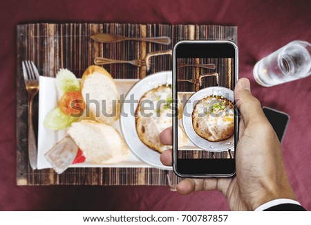 Taking food photography of homemade pan eggs fried and toasted bread, top view by smart phone