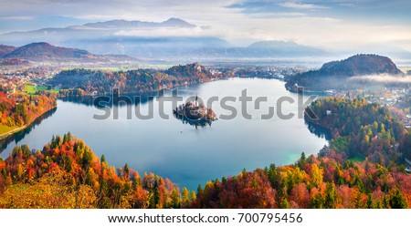 Aerial view of church of Assumption of Maria on the Bled lake. Sunny autumn landscape in Julian Alps, Slovenia, Europe. Beauty of countryside concept background.

