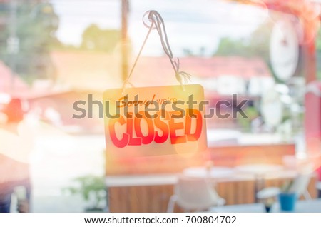 Closed sign hanging front of mirror door coffee shop double exposure with colorful bokeh light abstract background. Food drink and business service concept. Vintage tone filter color effect style.  
