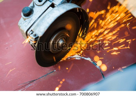 metal sawing with grinder close up