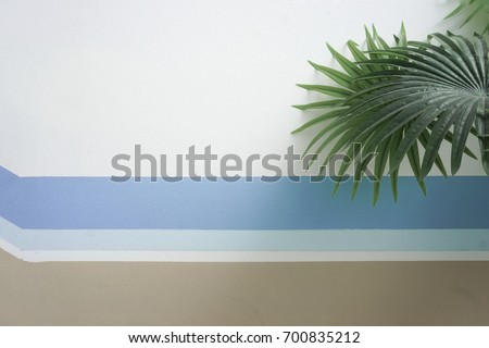 Wall painting and palm leaves for background Royalty-Free Stock Photo #700835212