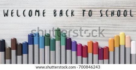 Welcome back to school background or banner. Multicolored pencils lie on a light wooden table. Beautiful tools for drawing. Knowledge Day design concept. Beautiful tools for drawing.Close Up. Flat Lay