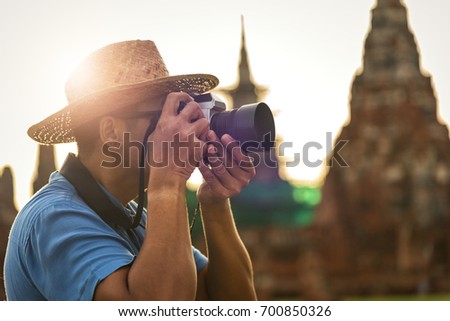 photographer stocker concept, foreign tourists take a picture at ayutthaya historical park