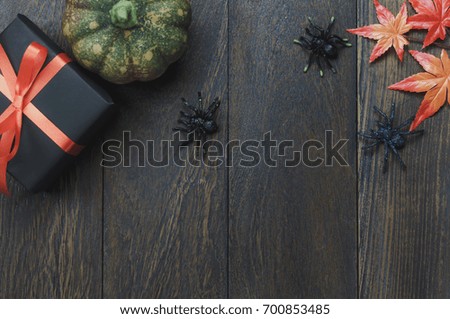 Table top of decoration sign Happy Halloween festival background. with beautiful pumpkin and maple leaf.Several object on modern rustic wooden desk.Copy space for text information.Dark tone design.