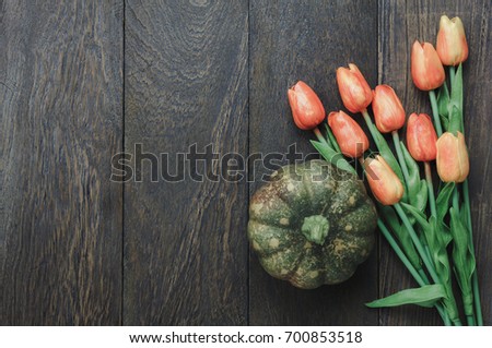 Table top of decoration sign Happy Halloween festival background. with beautiful orange tulip and pumpkin.Object on modern rustic wooden.Copy space for text information.Dark tone design.