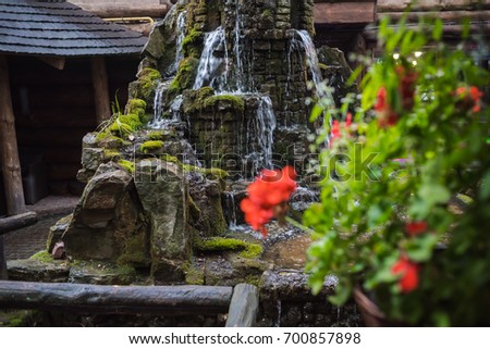 A small fountain in the backyard of a stone, an element of landscape design