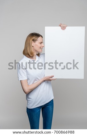 beautiful woman holding empty blank board, isolated on grey