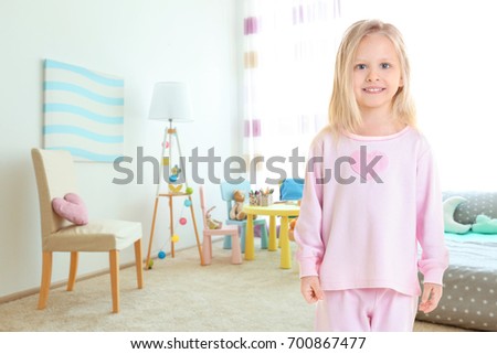 Cute little girl in children's room