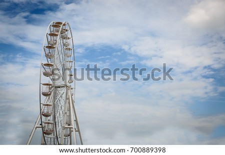 Special view of a noria for children and adults with the sky in the background, on a beautiful summer day