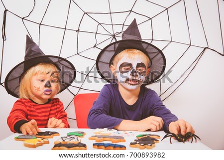 little girl and boy prepare for Halloween party