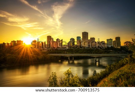 Sunset above Edmonton downtown, James Macdonald Bridge and the Saskatchewan River, Alberta, Canada. Long exposure. Royalty-Free Stock Photo #700913575