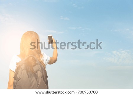 Traveler hiking photographer woman has take a photo of the blue sky on vacation and relaxing time with blue sky in the morning.