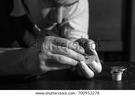 The watchmaker is repairing the mechanical watches in his workshop