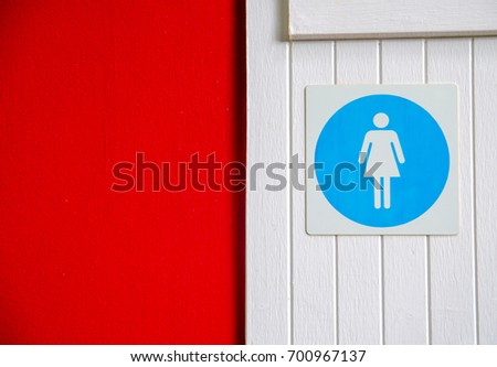 women toilet sign on white wood wall
