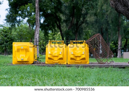 Yellow trash in public park.