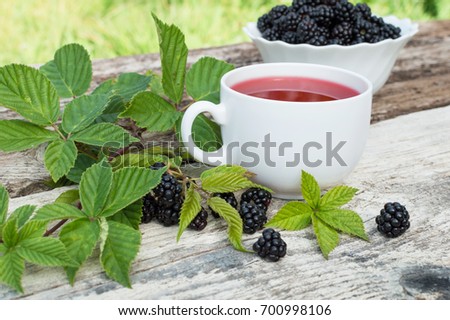 Cup of tea and blackberry plate