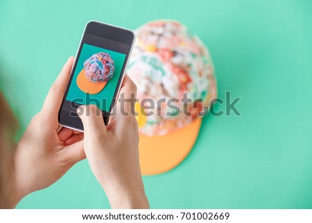 young women taking photo to hat with cell telephone or smartphone digital camera for Post to sell Online on the Internet . Customise pastel bright colors tone .