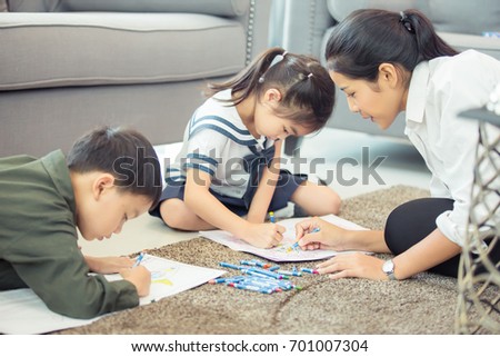 Mother Teaching children to do their homework at home ,and relax with they son to do home work by draw and paint, family , kid , education concept.