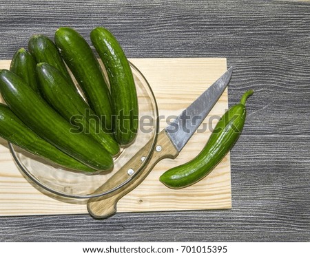 Cucumber pictures cut on the cutting board, cutting the cucumber with the knife,