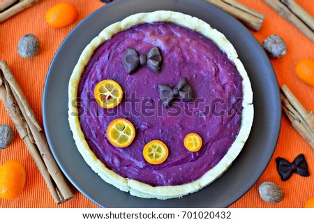 Spicy purple yam pie. This pie is vegan, gluten-free and sugar-free. Top view. Orange background