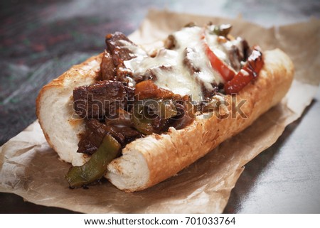 Philly cheese steak sandwich served on parchment paper Royalty-Free Stock Photo #701033764