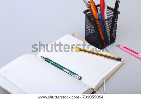 Open Blank Page notebook and pen on white table.