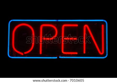 Illuminated open neon sign on black background