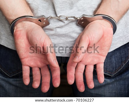 Police law steel handcuffs arrest crime human hand Royalty-Free Stock Photo #70106227