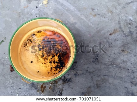 Yellow Bowl. In a Bowl of Oil is Used Leftover from Cooking. This is one of the causes of cancer. Royalty-Free Stock Photo #701071051
