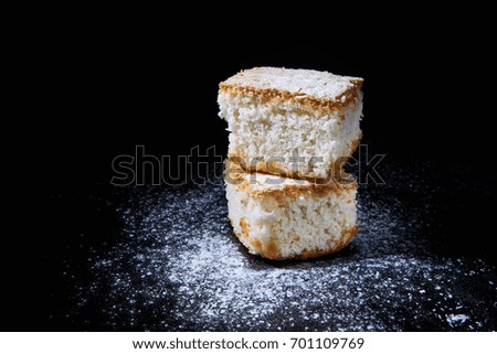coconut cake slices with icing sugar