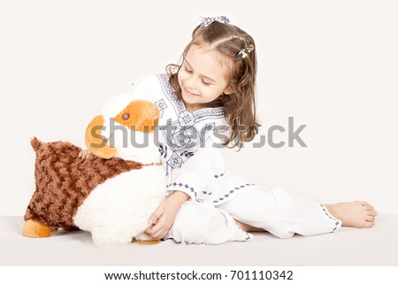 Happy little girl playing with her sheep toy - celebrating Eid ul Adha - Happy Sacrifice Feast Royalty-Free Stock Photo #701110342