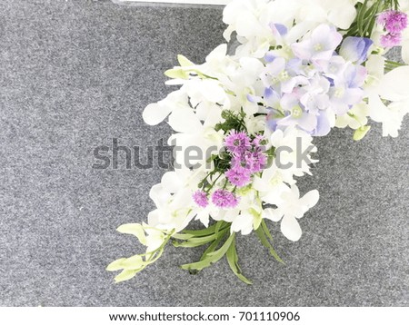 Close up of artificial flower bouquet on gray floor background