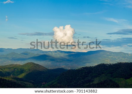 The green mountain landscape picture with the group of cloud and blue sky in the afternoon of green season in Thailand.