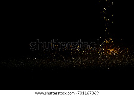 Sprinkle glitter gold dust in the dark with copy space