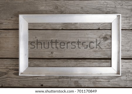 abstract of aluminum picture frame on the wooden background