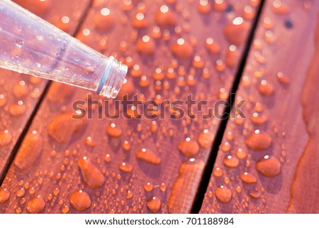 Empty bottle on a water drops background