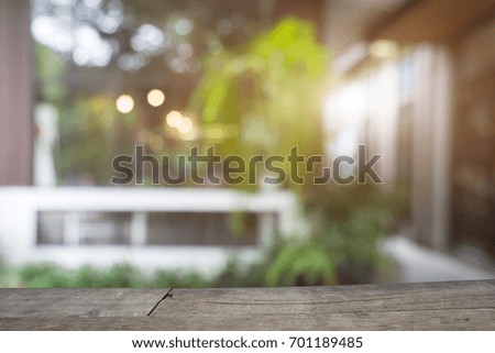 Conceptual workspace,Empty wooden table and blur background of home.