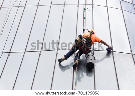 Glass cleaning by spiderman with safety equipment