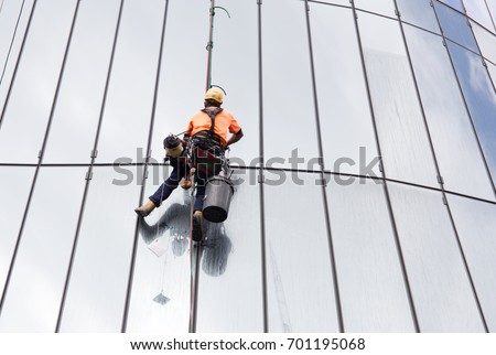 Glass cleaning by spiderman with safety equipment