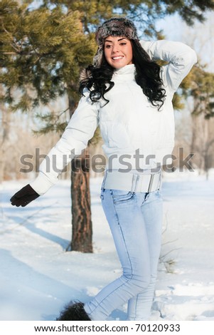 A young girl on a walk in a winter park. winter, snow, forest.