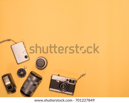 Flat Lay, Top View of Camera and photography tool on yellow background with space