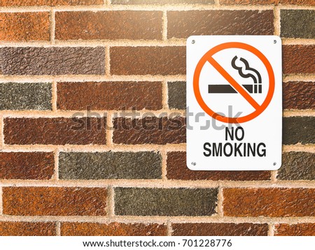 No smoking sign over the brick wall background. / With Copy Space