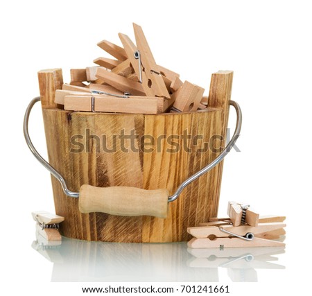 Bucket with wooden clothespins close-up isolated on white background.